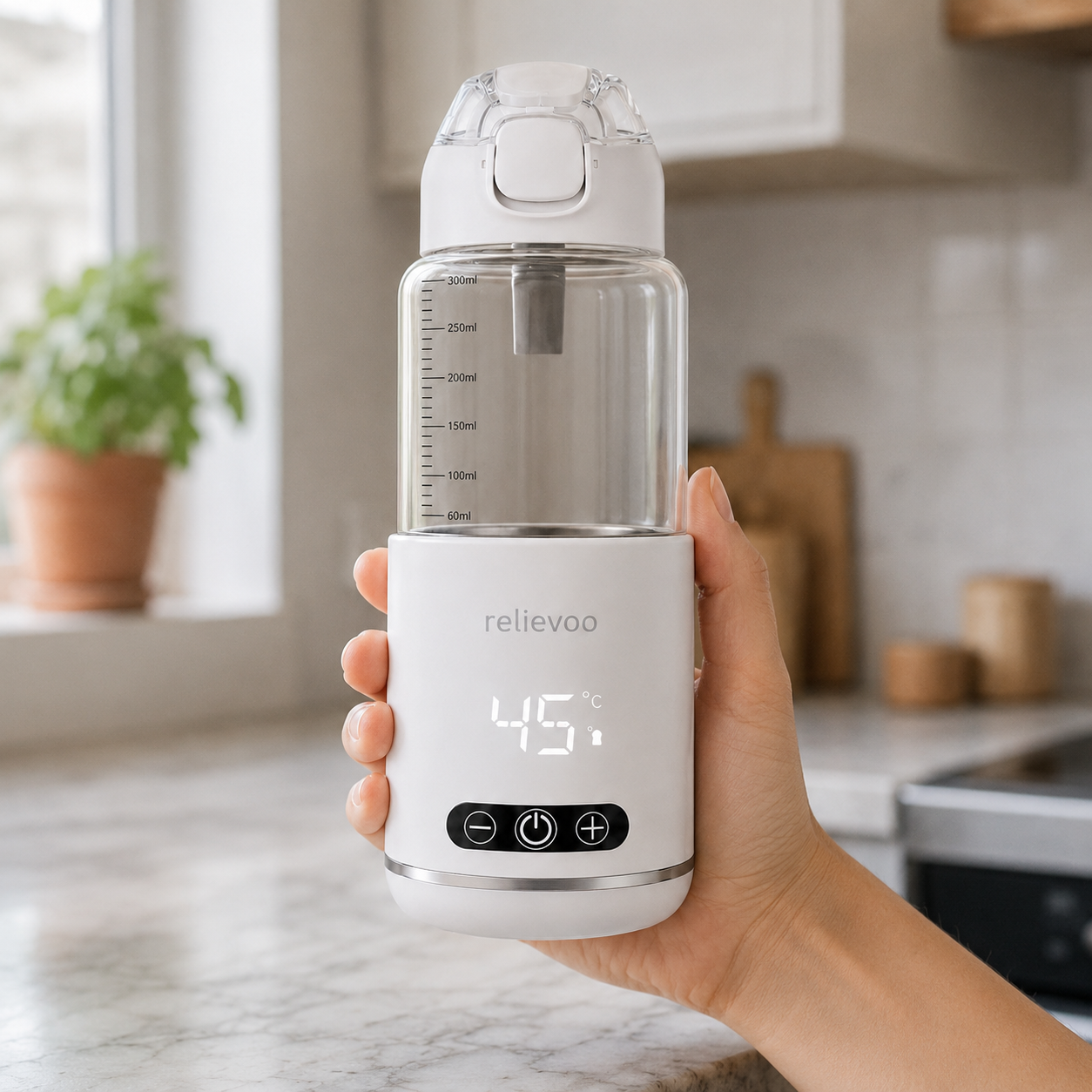 Compact Relievoo Portable Bottle Warmer Pro held in one hand in a modern Australian kitchen — ~20cm cordless USB-C baby bottle warmer easily fits in a nappy bag for travel
