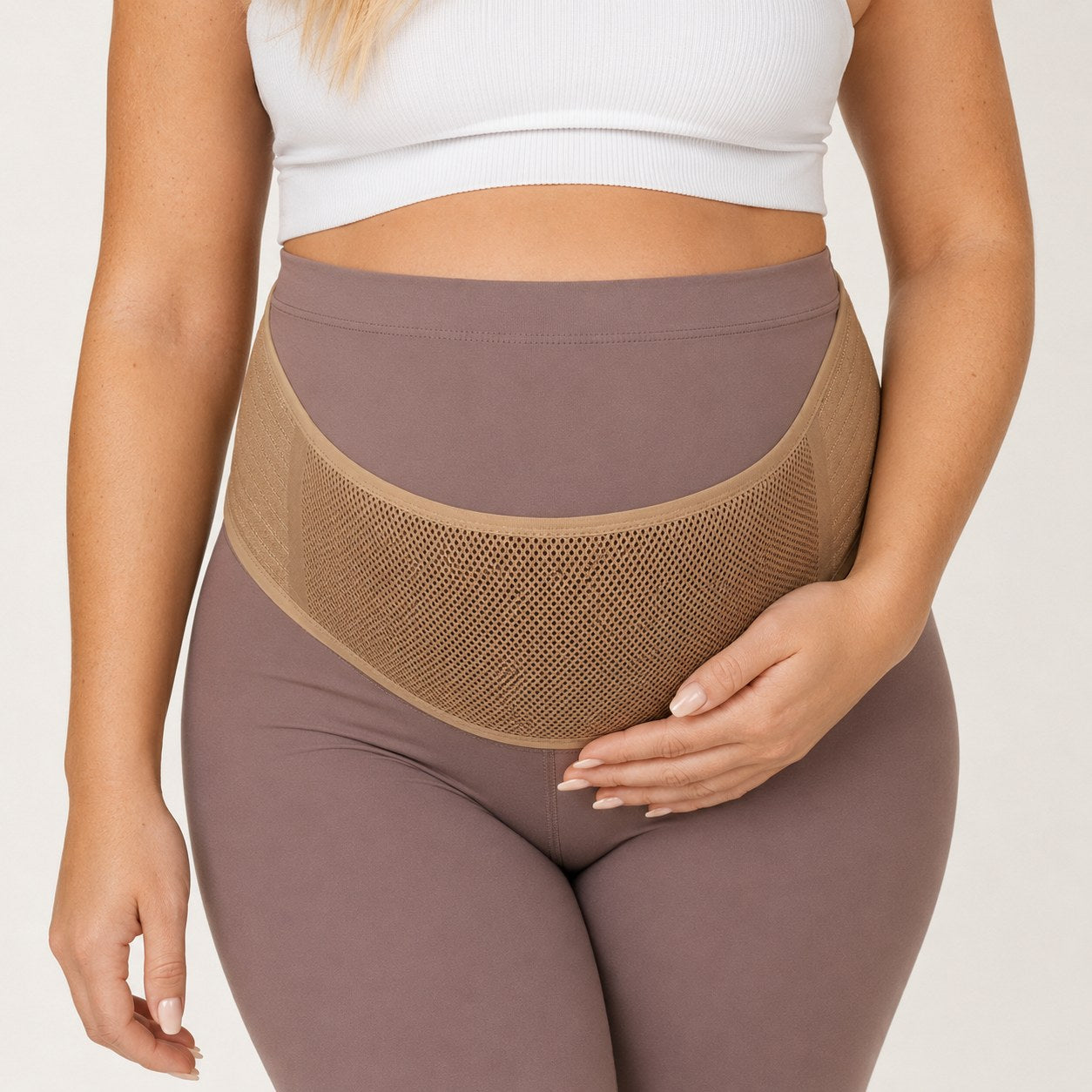 Close-up of the breathable mesh Relievoo Pregnancy Belly Band in beige supporting the baby bump