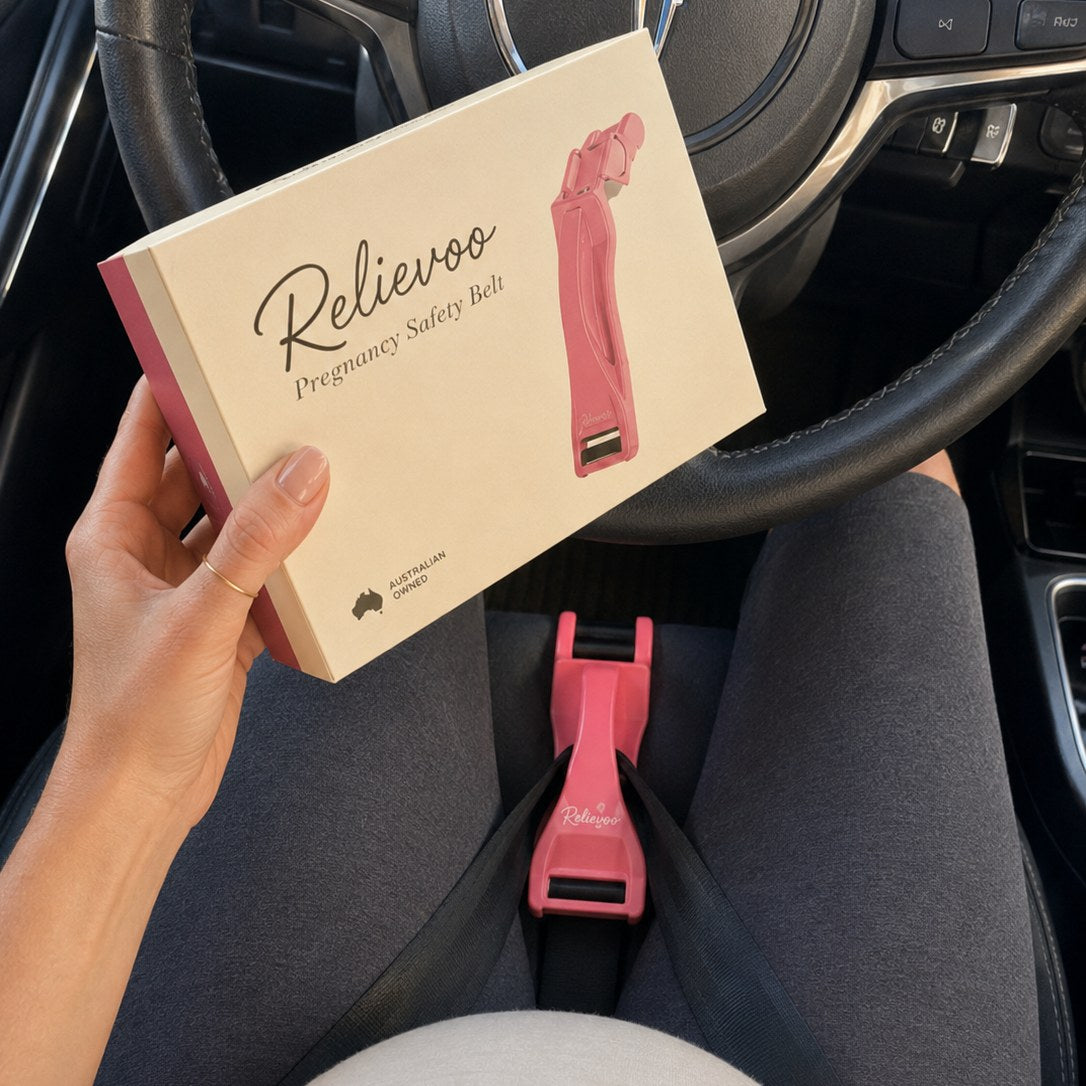 Relievoo Pregnancy Safety Belt cream box and pink seatbelt adjuster fitted low in the car, Australian owned